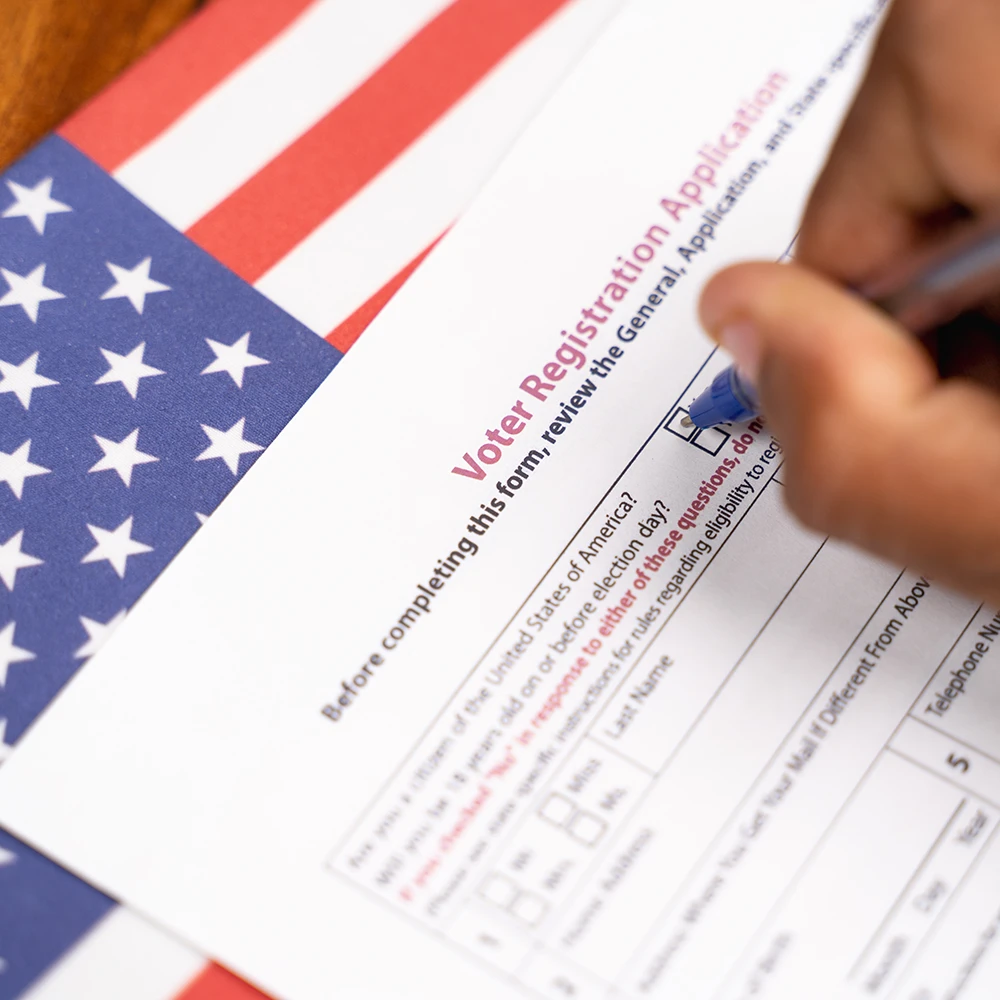 Person filling out a voter registration form