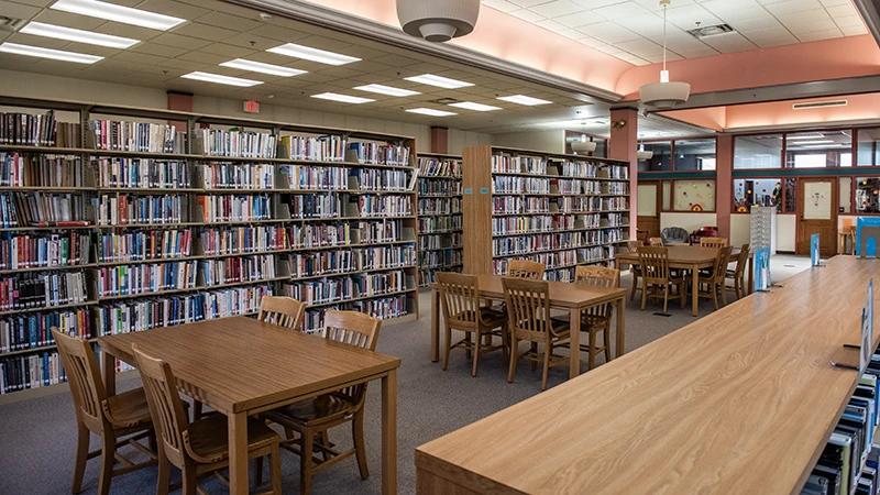 inside the Flagg-Rochelle Public Library showing several tables and multiple book shelves